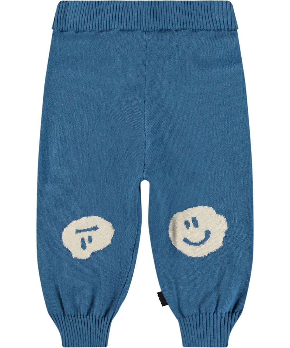 Sol - Lagoa - Gebreide babybroek van biologisch katoen. Het is blauw met smiley's op de knietjes.
