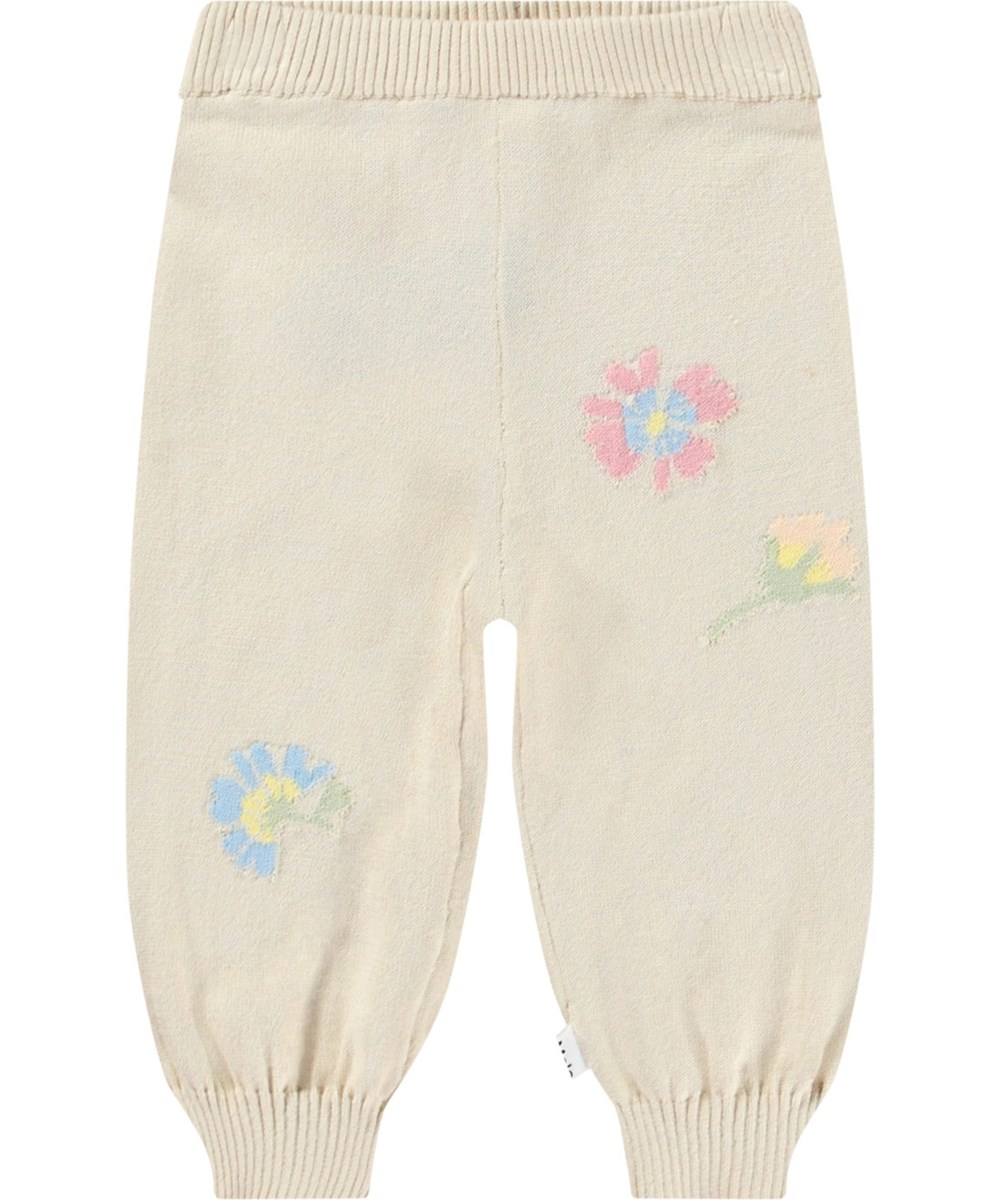 Sol - Pastel Flora - Gebreide babybroek van biologisch katoen. Het is lichtbeige met mooie bloemen