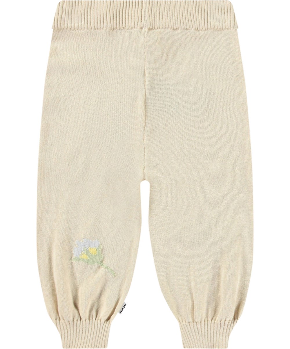 Sol - Pastel Flora - Gebreide babybroek van biologisch katoen. Het is lichtbeige met mooie bloemen