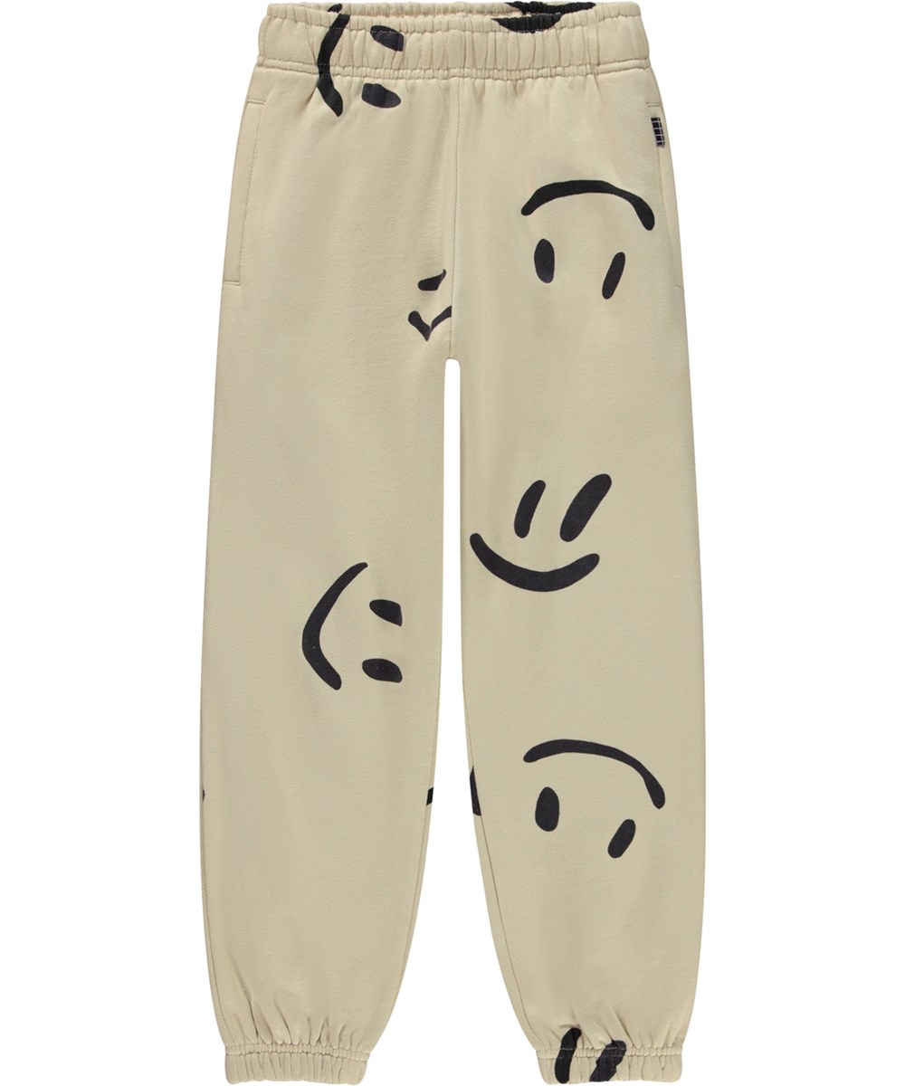 Adan - Big Smiles - Beige økologiske joggingbukser med stort allover smil print
