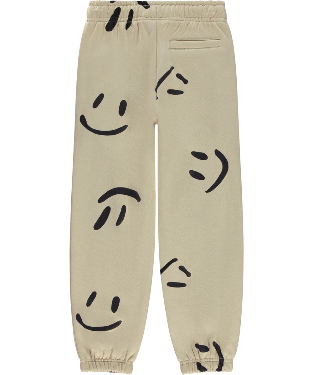 Adan - Big Smiles - Beige økologiske joggingbukser med stort allover smil print