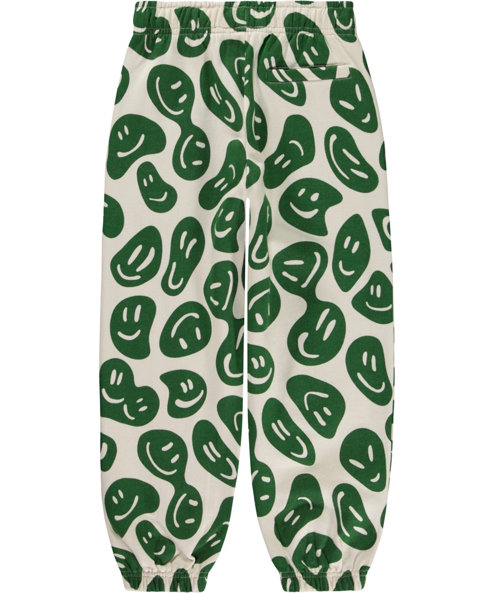 Adan - Smile On Nature - Hvide økologiske joggingbukser med allover grønt smil print