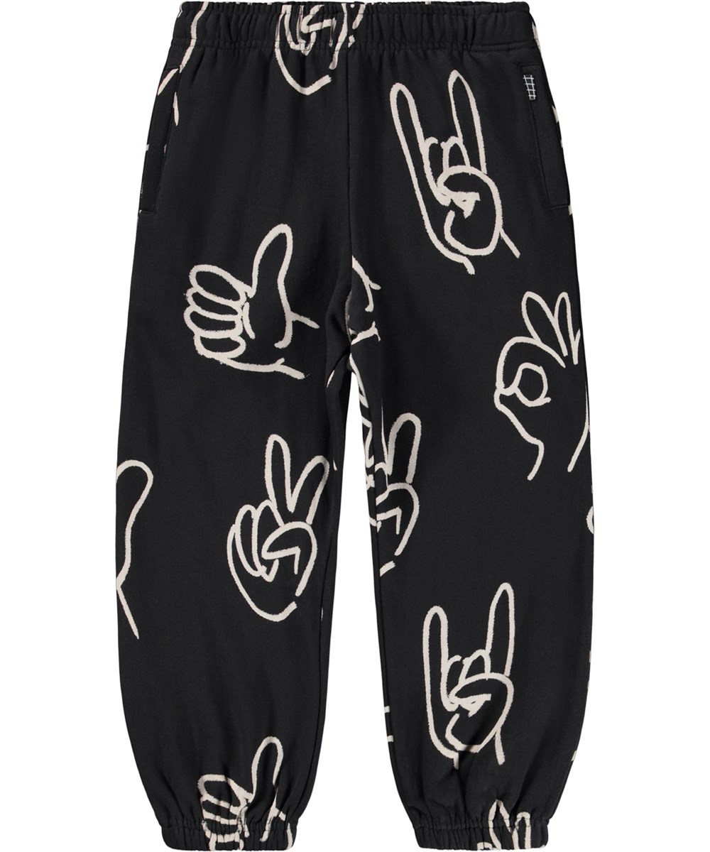Adan - Drawn Hands - Schwarze Jogginghose für Kinder aus Öko-Baumwolle mit einem Handzeichen-Druck.