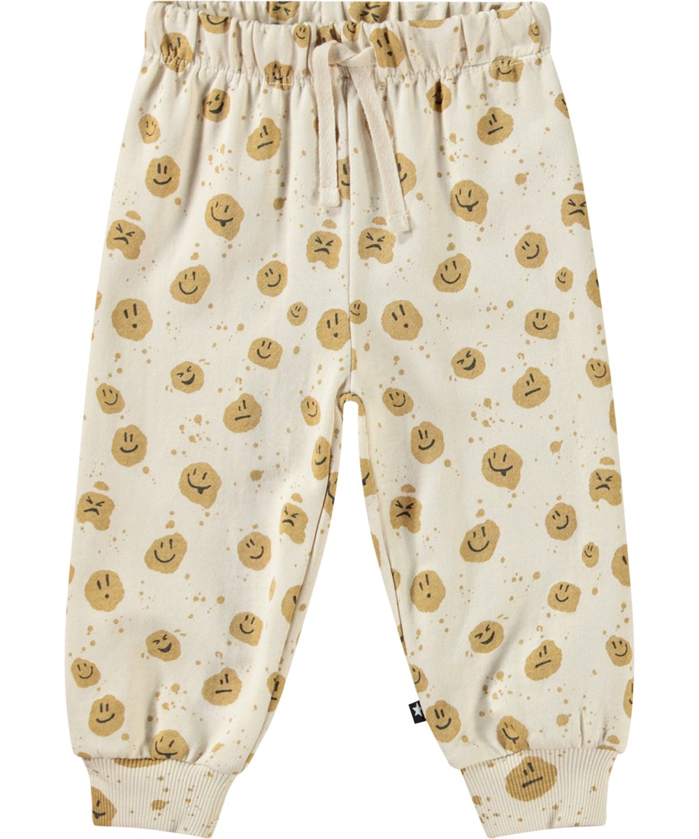 Simeon - Mood Dots - Weiche Hosen aus Öko-Baumwolle für Babys. Die Hosen sind beige mit lächelnden Gesichtern.