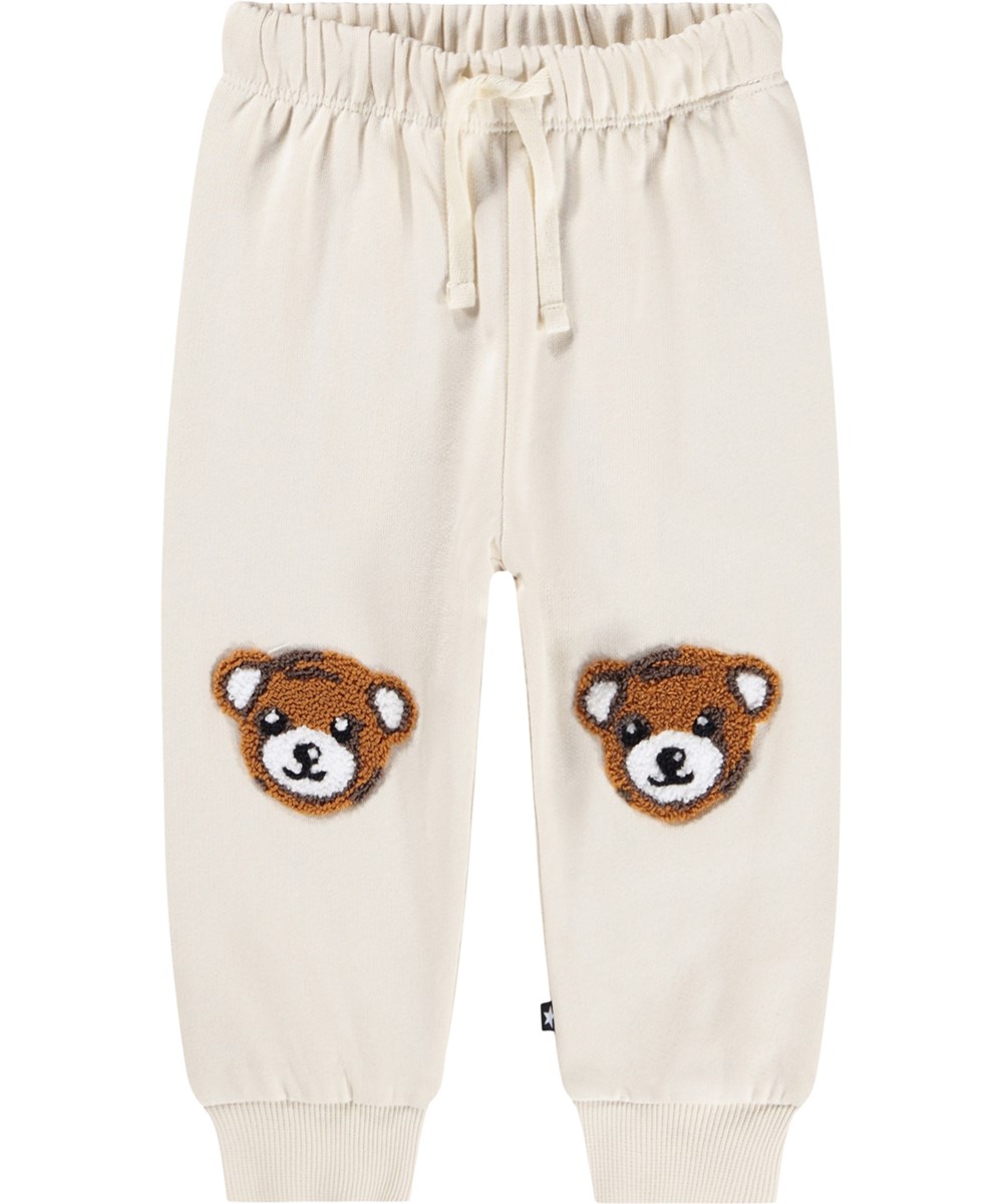 Simeon - White Noise - Weiche Hosen für die Kleinen aus Öko-Baumwolle. Die Hosen sind cremefarben mit weichen braunen Teddybären auf den Knien.