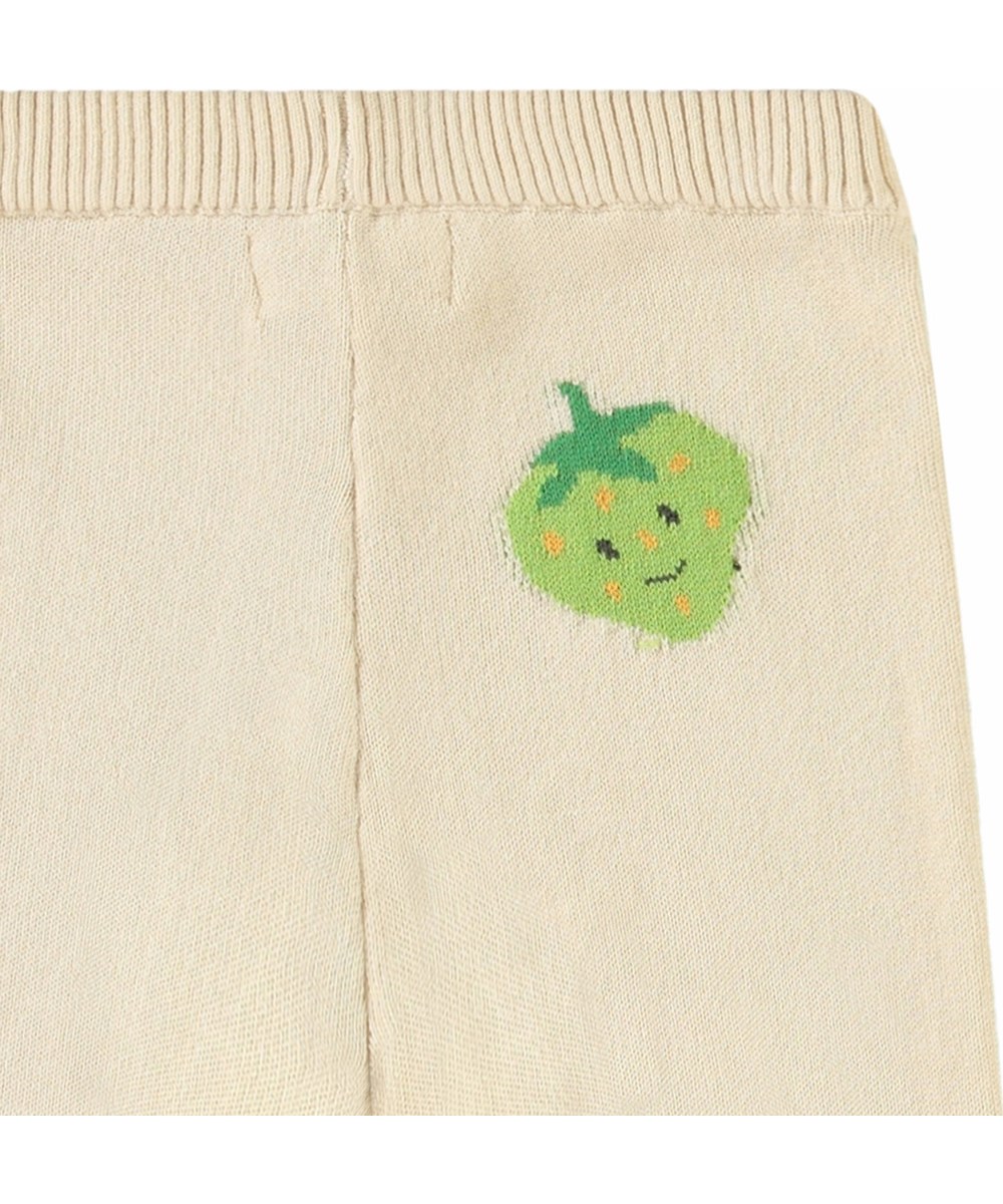 Sol - Cute Fruits - Gestrickte Hose aus Öko-Baumwolle für Babys. Gestrickt in hellem Beige und verziert mit niedlichen Früchten.