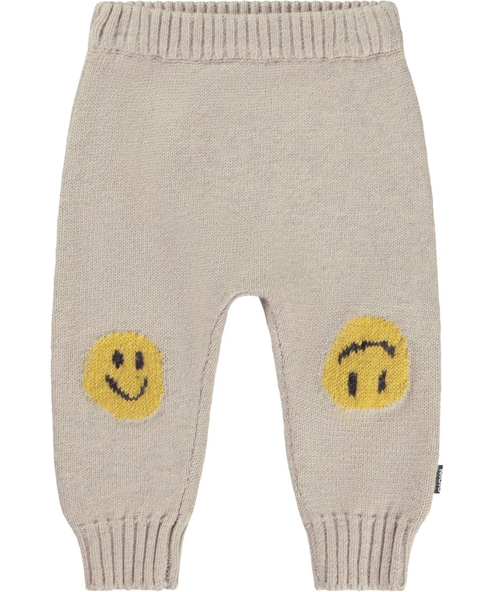Sol - Ridge - Beige gestrickte Babyhose mit einem Lächeln auf den Knien