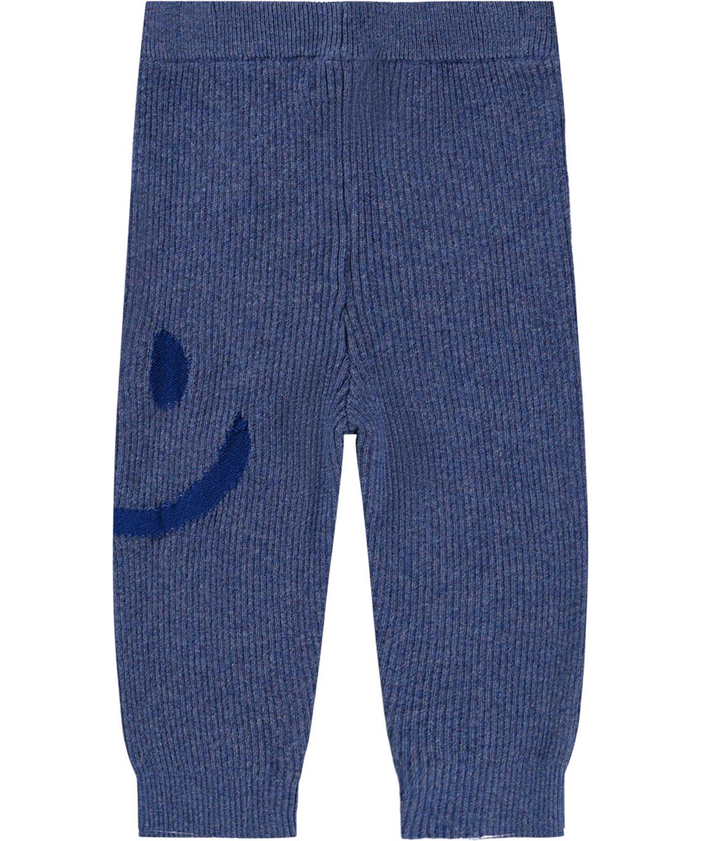 Stinus - Evening Sky - Blaue gestrickte Hosen für die Kleinen aus weicher Baumwolle und Wollrippung mit einem lächelnden Gesicht auf dem Oberschenkel.