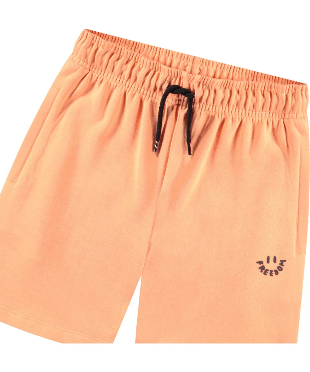Adian - Cantaloupe - Oranje biologisch katoenen joggingshort voor kinderen.