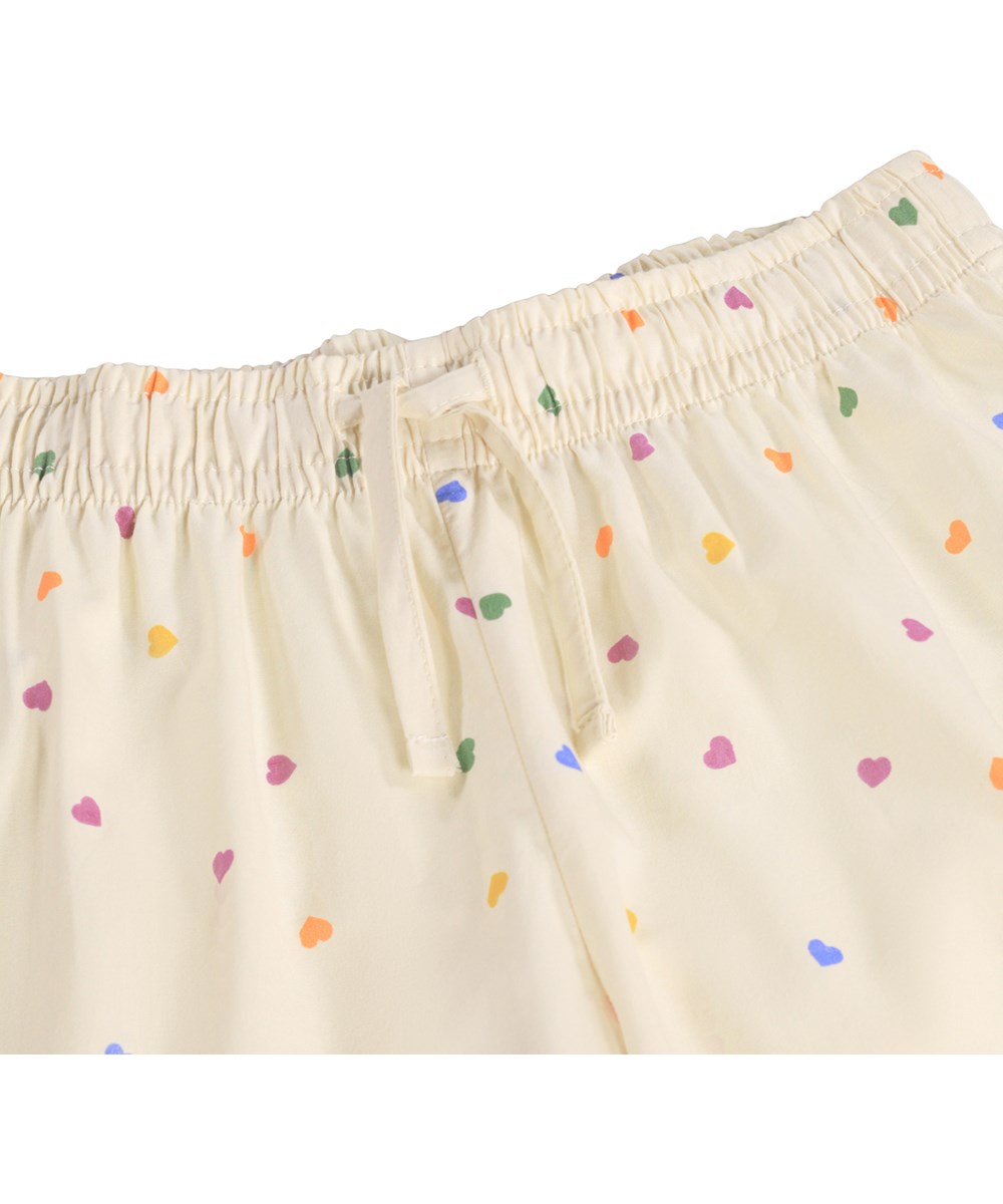 Lex - Confetti_Rainbow - Beige pyjama set for children made of organic cotton with a print 