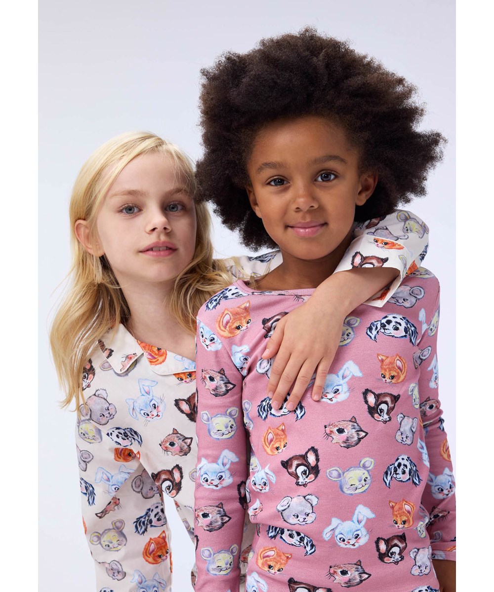 Lex - Itty Bitty Cream - Off-white pyjama set for children made of organic cotton with a print of cute drawn animals.