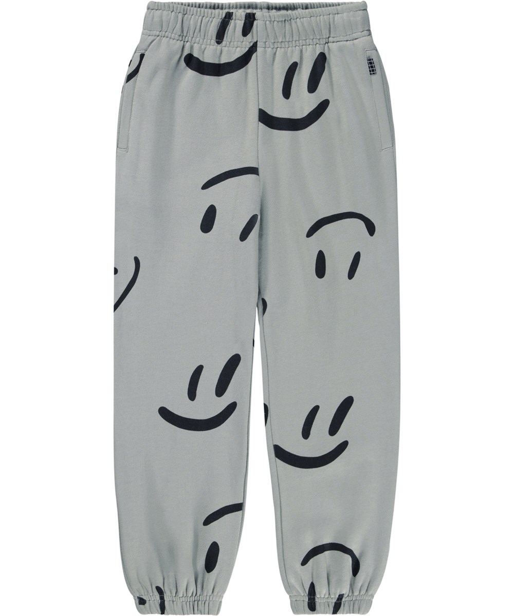 Adan - Big Smiles Fall - Grey sweatpants for children made of organic cotton with a print of smiling faces.