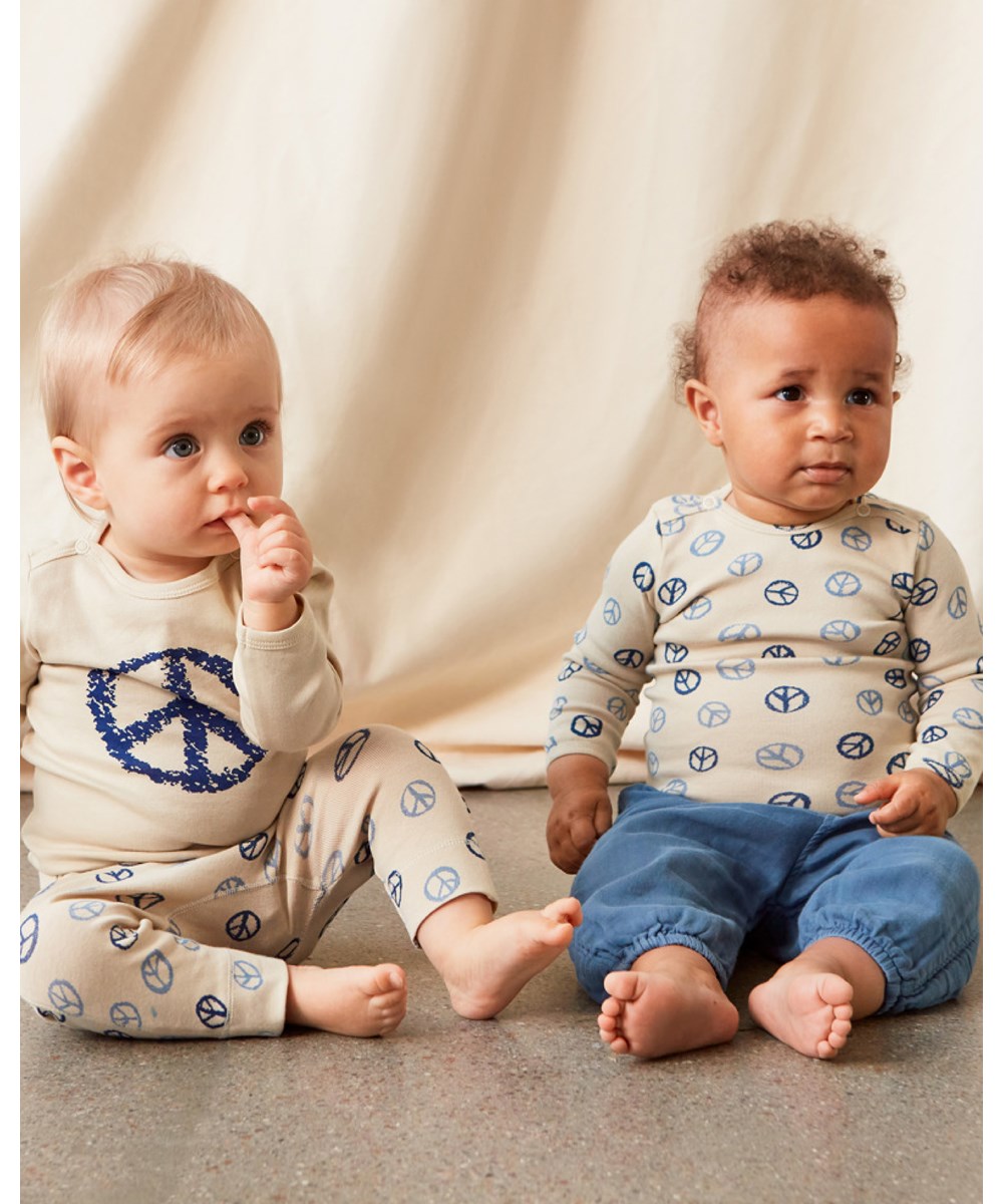 Seb - Peace All Over - Beige baby trousers with peace sign