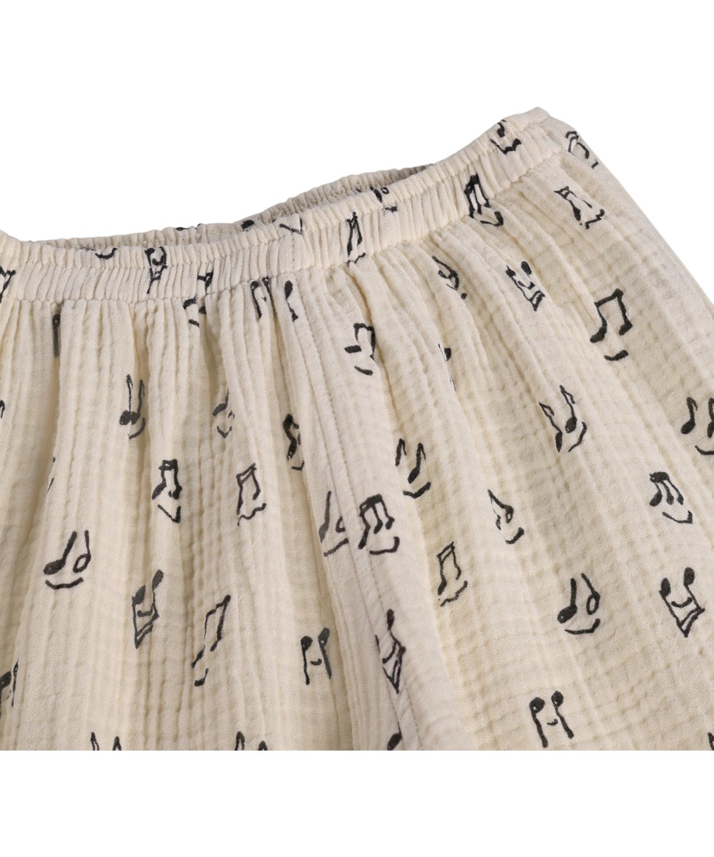 Serene - Happy Notes - Soft, cream-coloured trousers for the little ones made organic cotton with a music print 