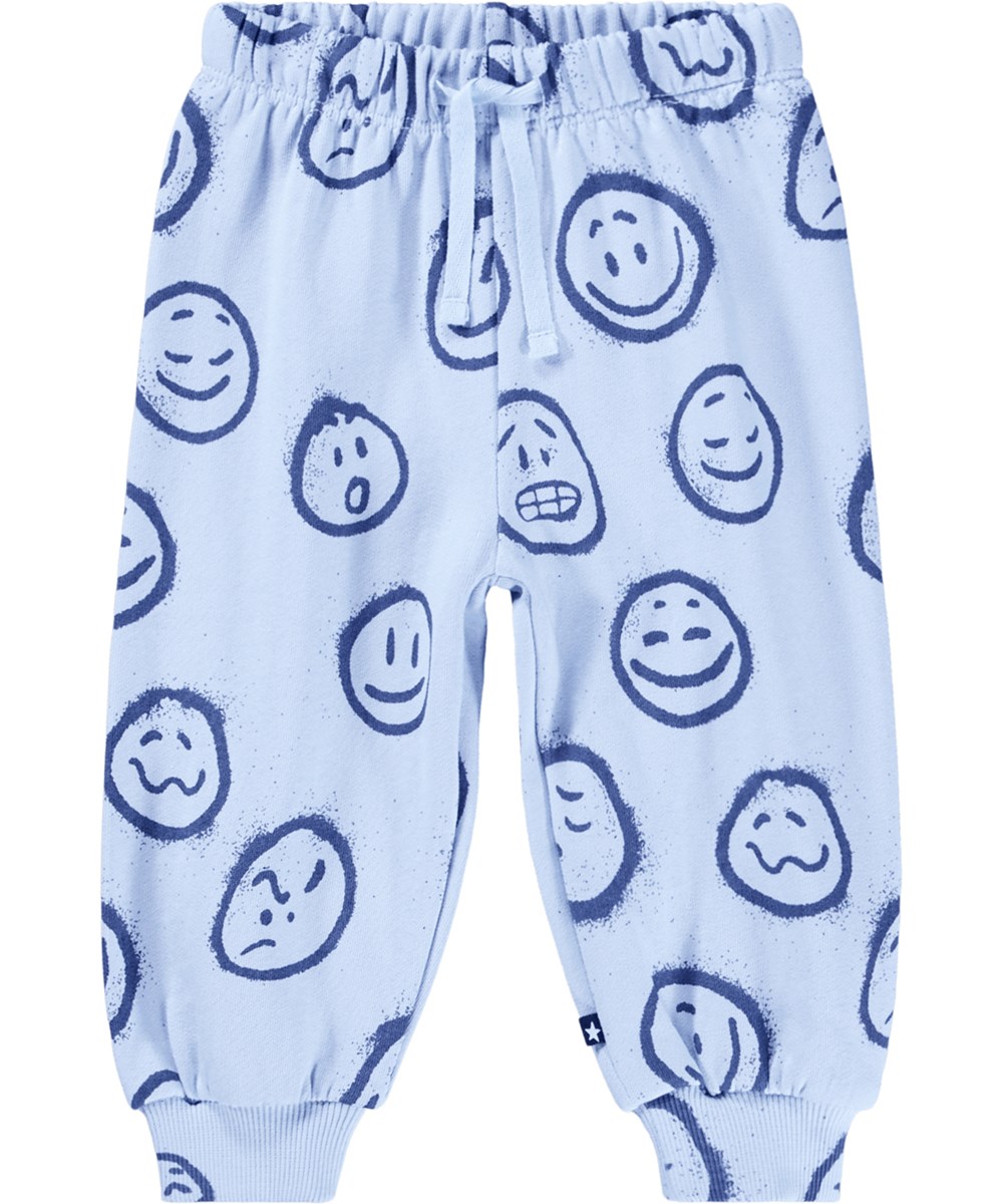 Simeon - Blue Moon Moods - Soft light blue pants for the little ones made of organic cotton with a print of blue faces in different moods.