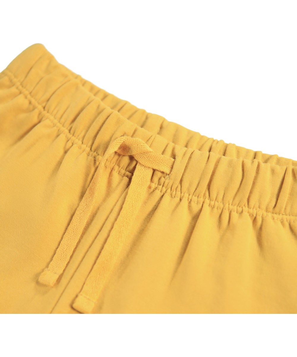Simeon - Energy - Soft yellow pants for the little ones made of organic cotton with soft white faces on knees.