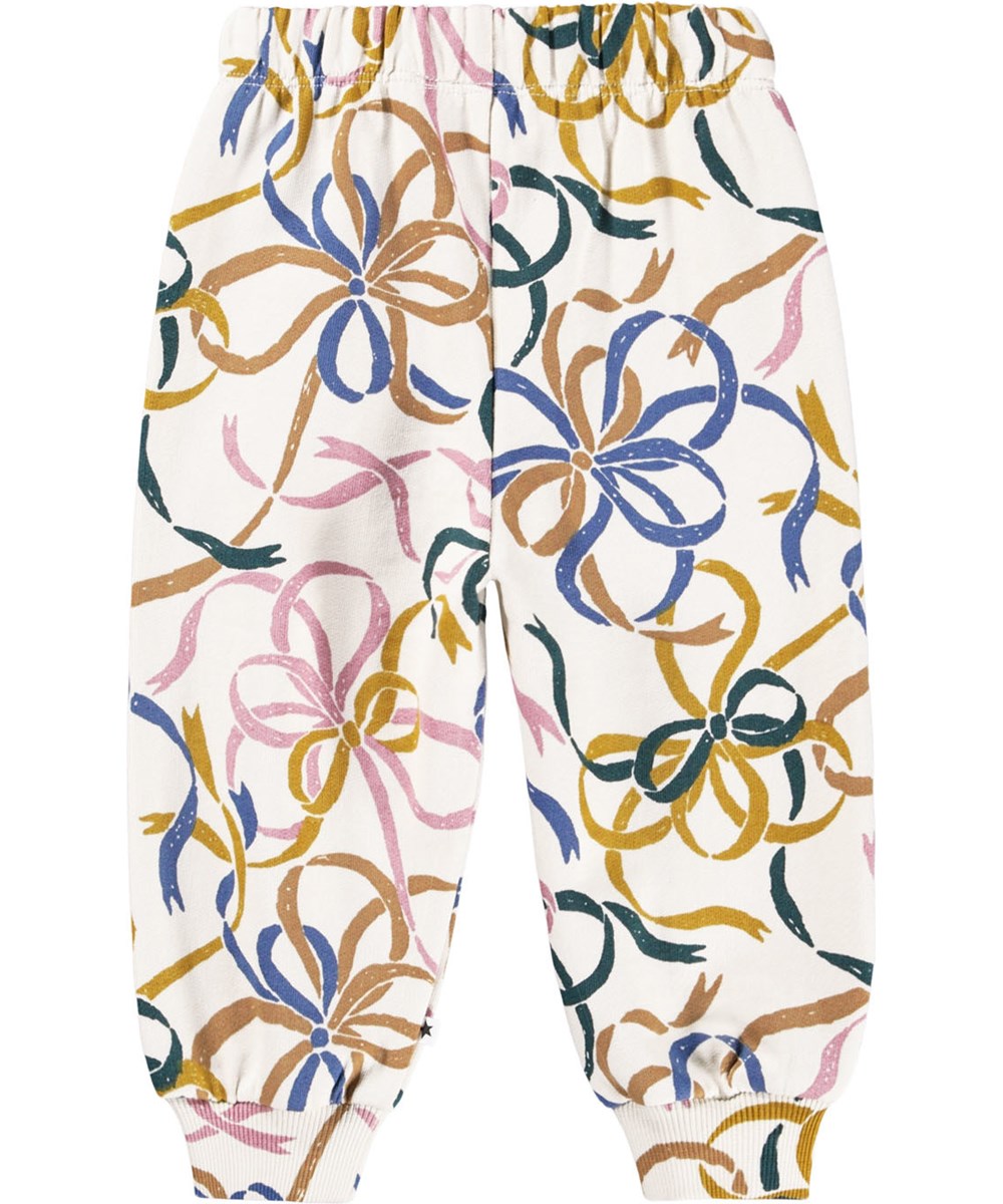 Simeon - Festivity Bows - Soft off-white pants for the little ones made of organic cotton with a print of colorful bows.