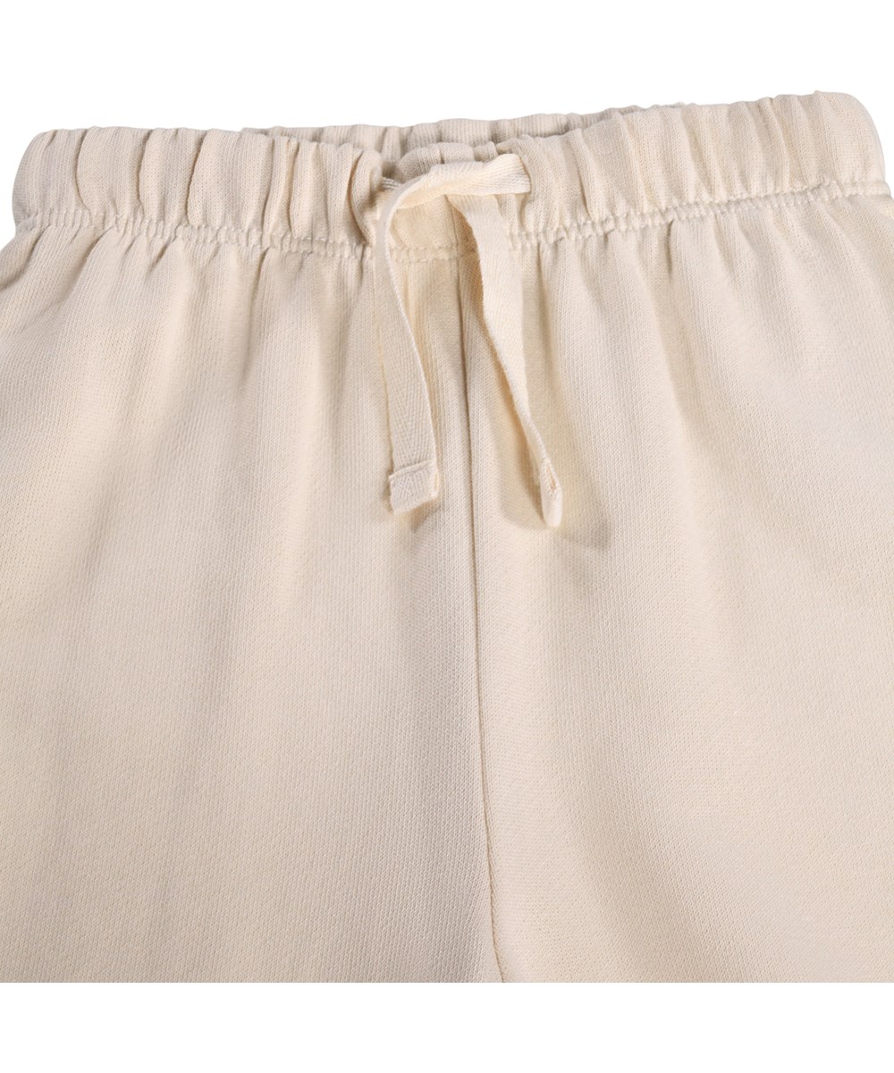 Simeon - Little Rainbow - Soft, cream-coloured sweatpants for the little ones made of organic cotton with a rainbow print