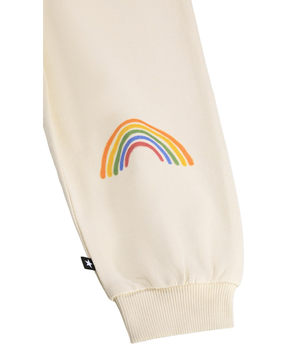 Simeon - Little Rainbow - Soft, cream-coloured sweatpants for the little ones made of organic cotton with a rainbow print