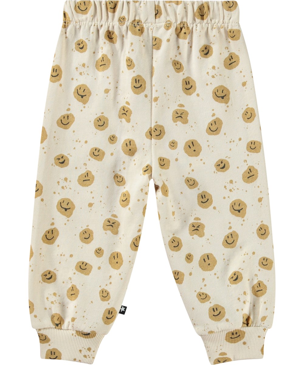 Simeon - Mood Dots - Soft pants in organic cotton for baby. The pants are beige with smiling faces.