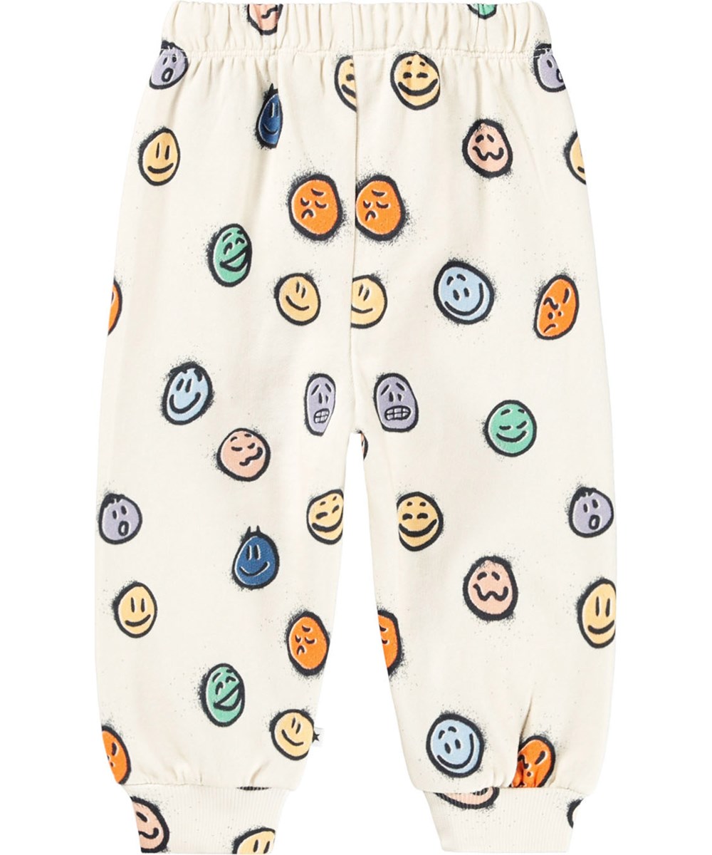 Simeon - Multi Moods - Soft off-white pants for the little ones made of organic cotton with a print of colorful faces in different moods.