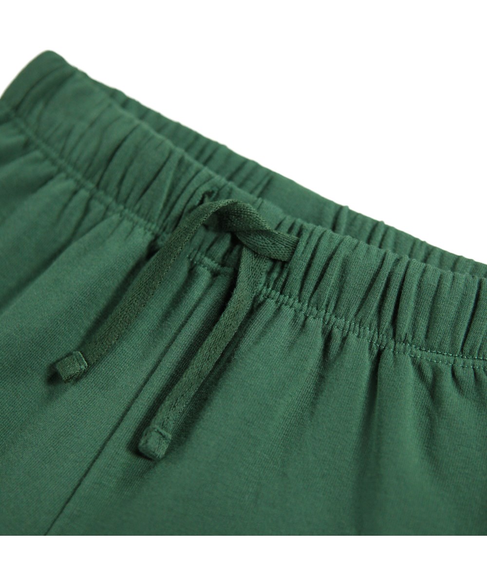 Simeon - Pine Tree - Soft green pants for the little ones made of organic cotton with soft white faces on knees.