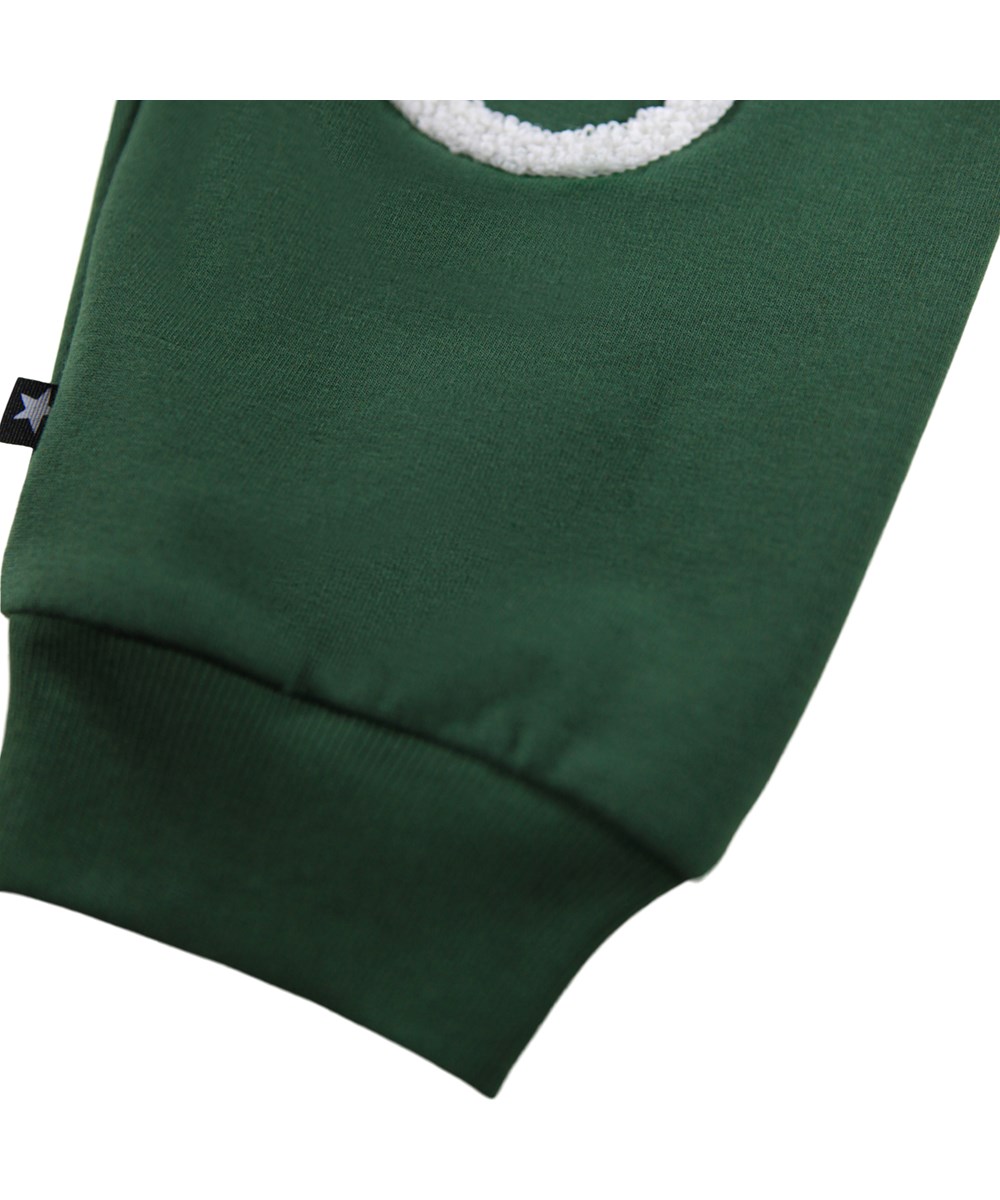 Simeon - Pine Tree - Soft green pants for the little ones made of organic cotton with soft white faces on knees.