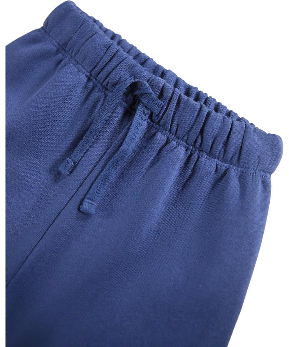 Simeon - Toy Elephant - Soft pants for the little ones made of organic cotton. The pants are dark blue with blue elephant teddies on the knees.