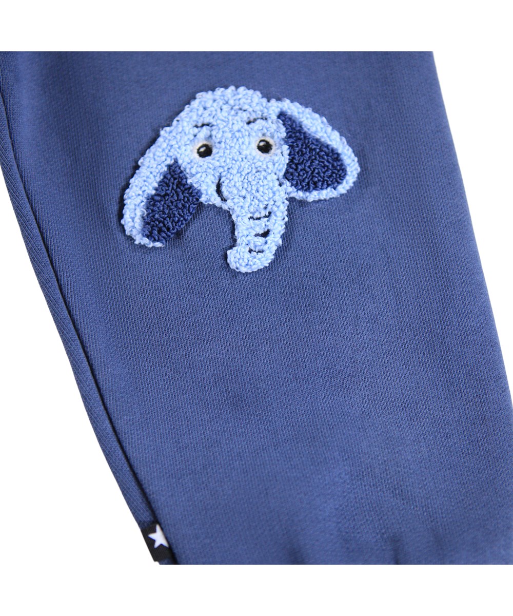 Simeon - Toy Elephant - Soft pants for the little ones made of organic cotton. The pants are dark blue with blue elephant teddies on the knees.