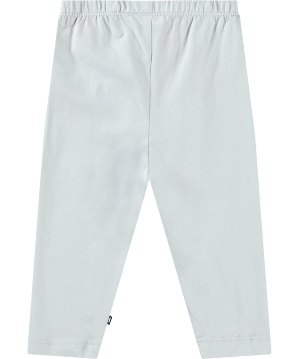 Simway - Skywriting - Pants in organic cotton jersey for baby. It has a close-fitting with elastic waist. The trousers are light blue with a print of smiling faces on the knees.