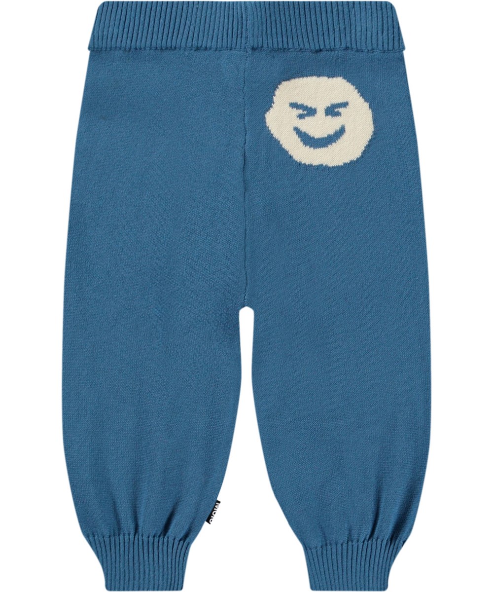 Sol - Lagoa - Knitted pants in organic cotton for baby. Knitted in blue with smiling faces decorated on the knees.