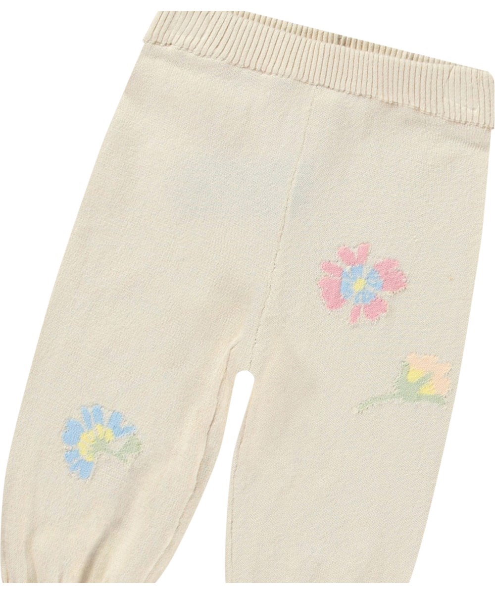Sol - Pastel Flora - Knitted pants in organic cotton for baby. Knitted in light beige adorned with delicate flowers.