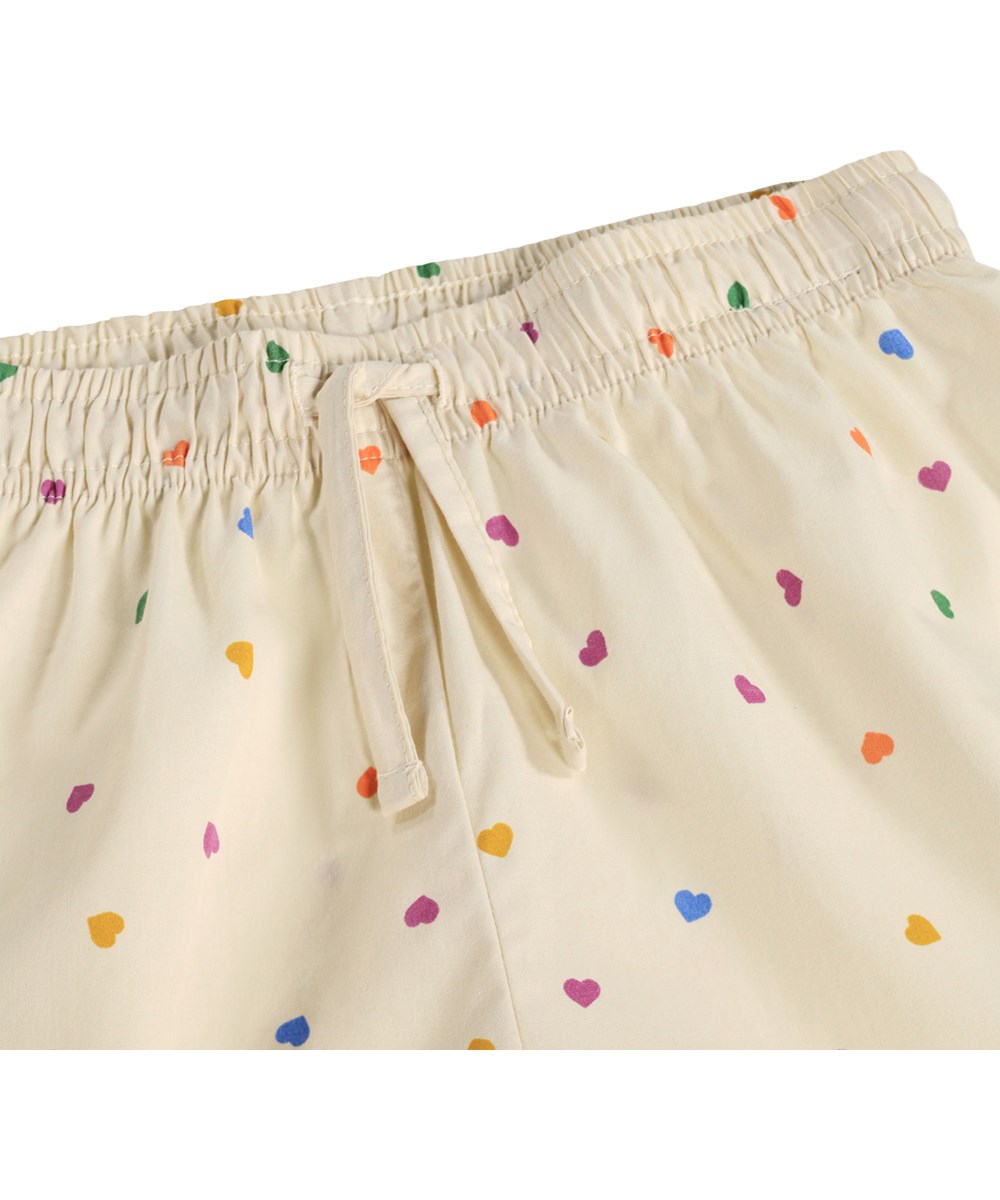 Lexi - Confetti_Rainbow - Beiges Pyjama-Set für Kinder aus Bio-Baumwolle mit Druck