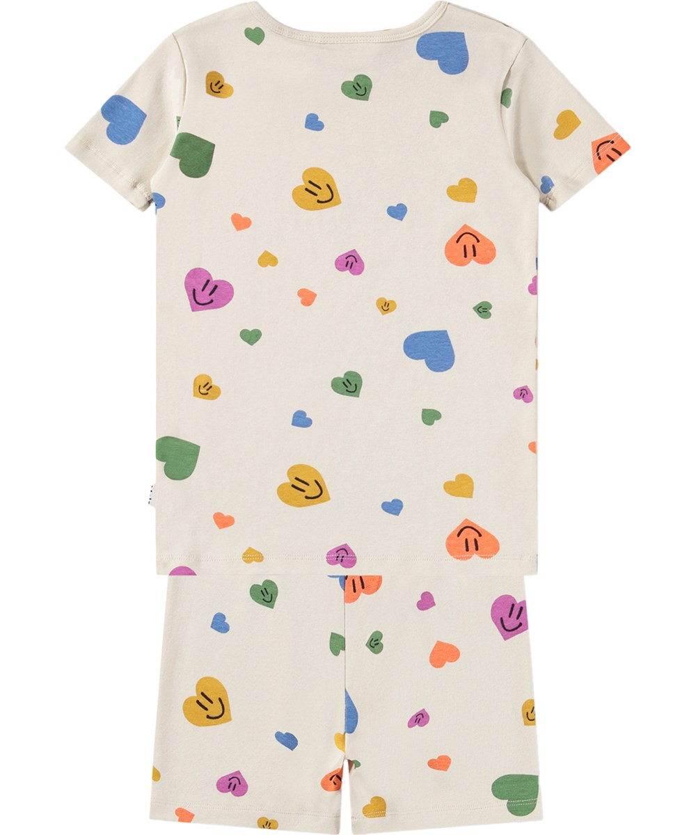 Lou US - Confetti Smiles - Beige zweiteilige Kinderpyjamas aus Bio-Baumwolle mit Herzmuster