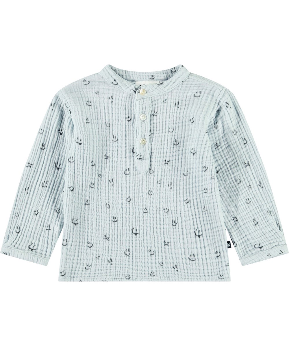 Enoz - Moods - Shirt in organic crinkled cotton for babies. The shirt features a print of smiling faces.
