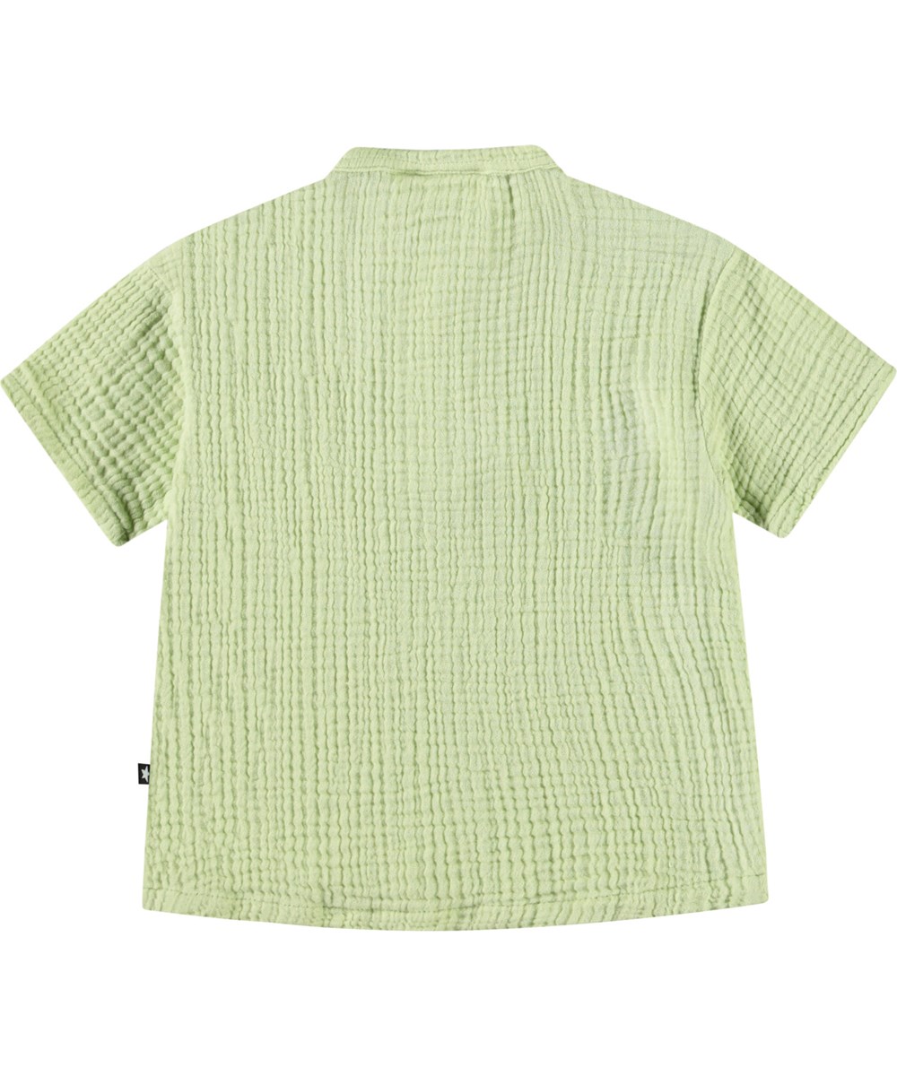 Ever - Misty Green - Short-sleeved shirt with buttons in organic crinkled cotton for a baby. The shirt is light green with a small embroidered smiling face.