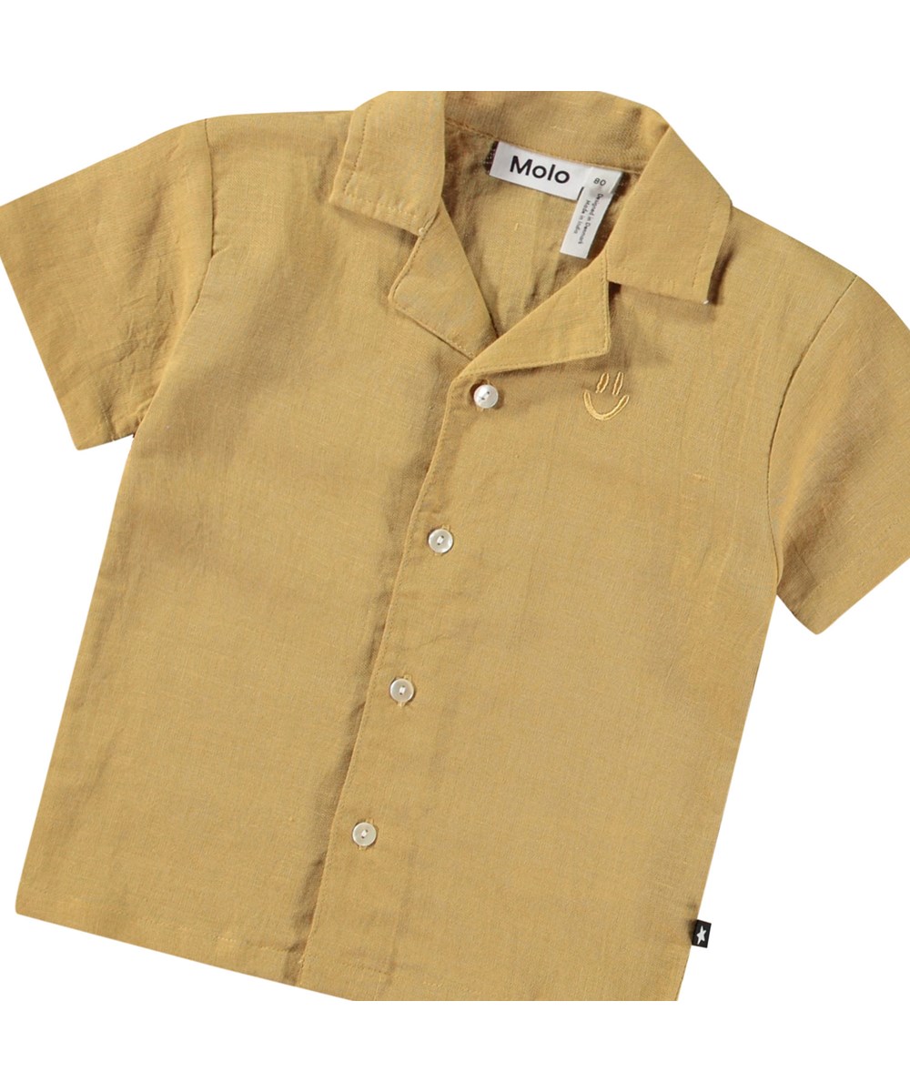 Eyou - Suede - Short-sleeved shirt in organic cotton for baby. The shirt is brown with an embroidered smiling face.