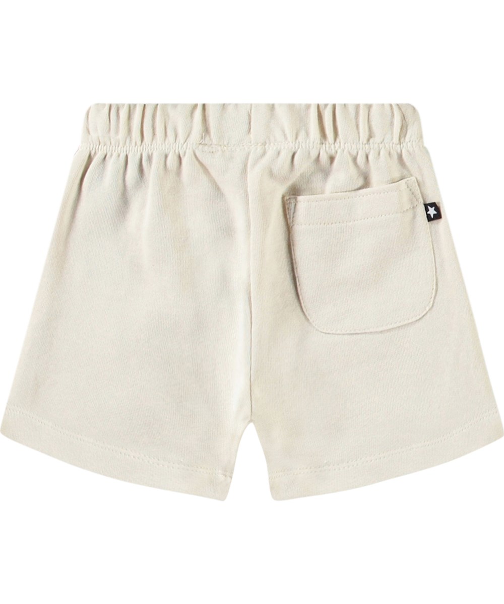Simms - Summer Sand - Soft shorts in organic cotton for baby. These shorts are light beige with an embroidered smiling face.