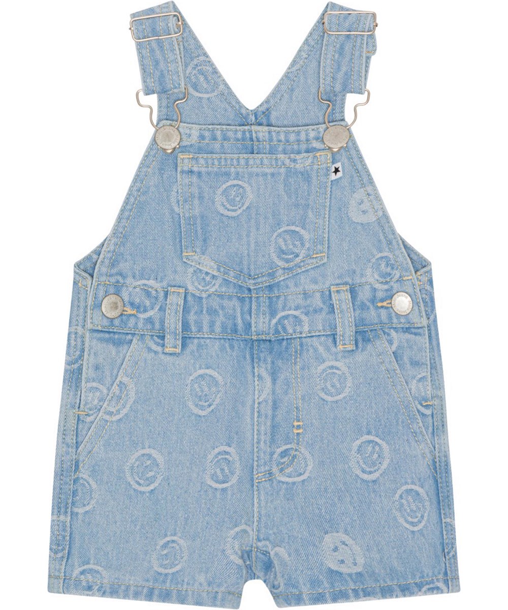 Spot - Happiness Light - Dungarees in blue denim with small smiling faces woven into the fabric 