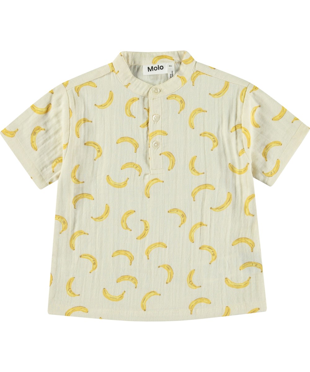 Ever - Cute Bananas - Kortærmet skjorte med knapper i økologisk crepet bomuld til baby. Skjorten er beige med print af bananer.