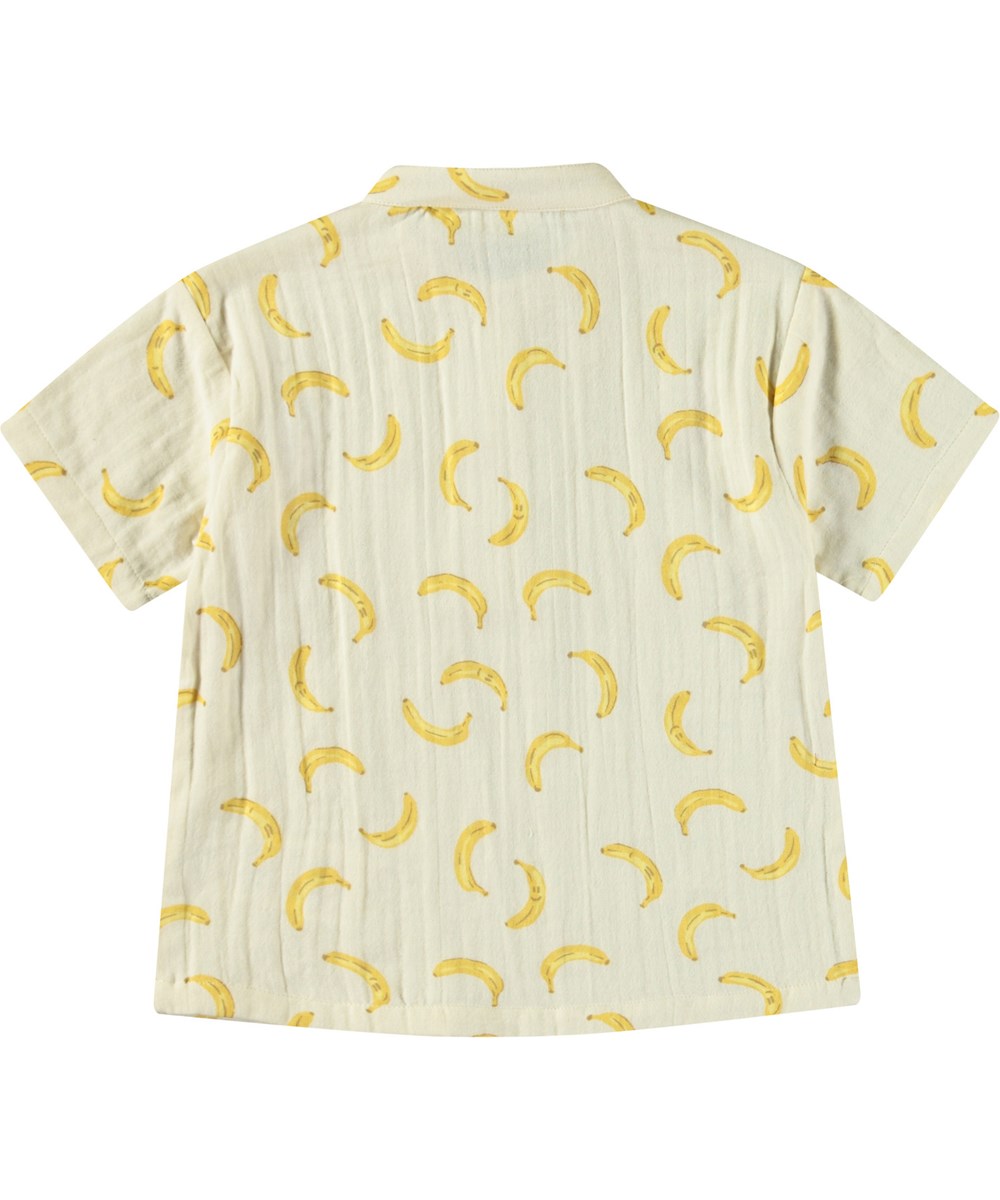 Ever - Cute Bananas - Kortærmet skjorte med knapper i økologisk crepet bomuld til baby. Skjorten er beige med print af bananer.