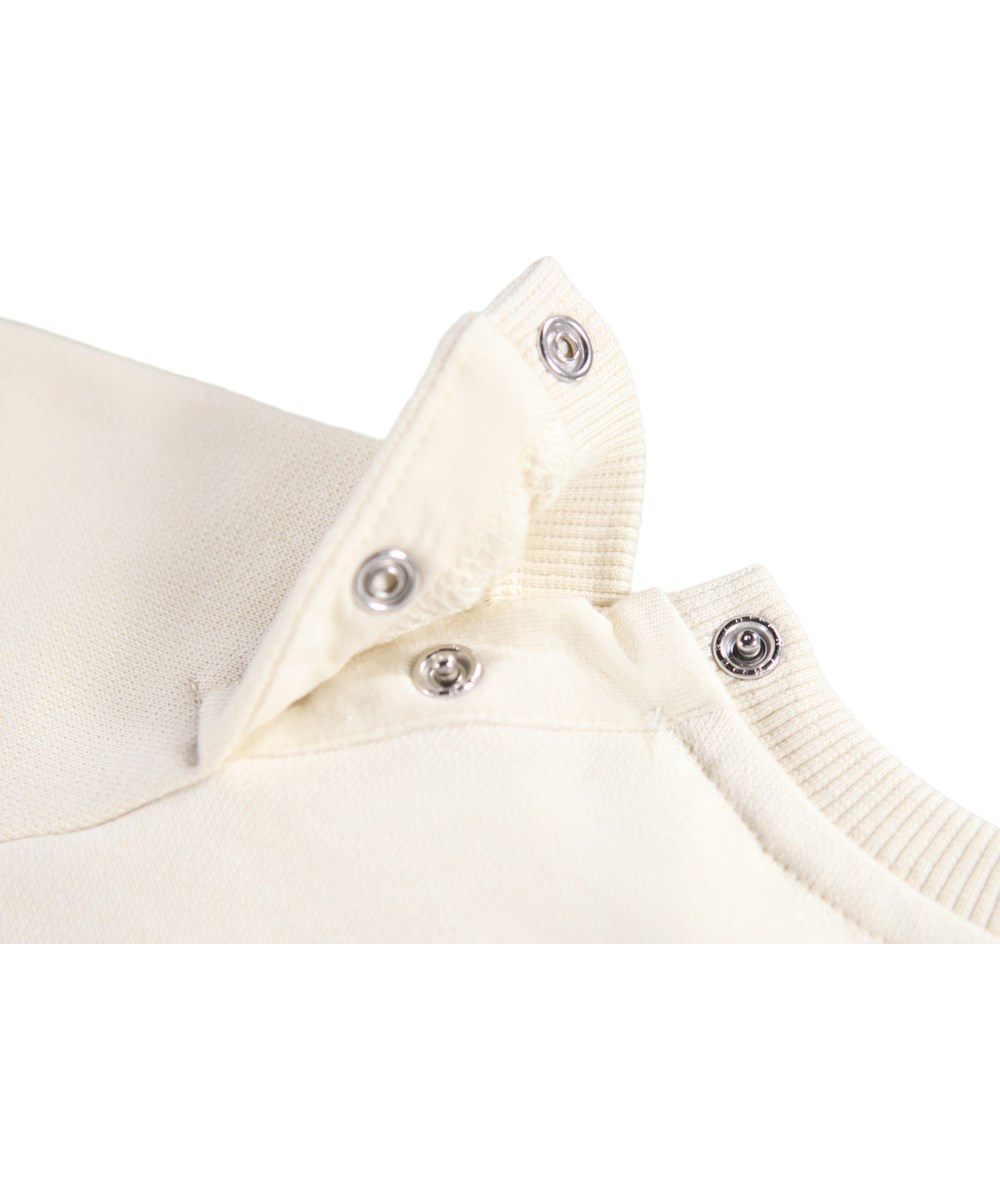 Disc - White Noise - Off-white sweatshirt for the little ones made of soft organic cotton with an embroidered teddy bear face on the front.