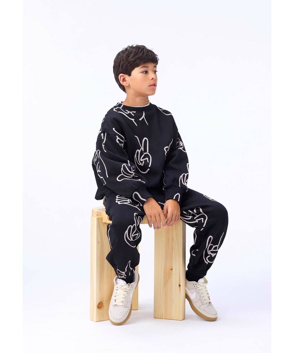 Monti - Drawn Hands - Black sweatshirt for children made of soft organic cotton with a hand-drawn design.