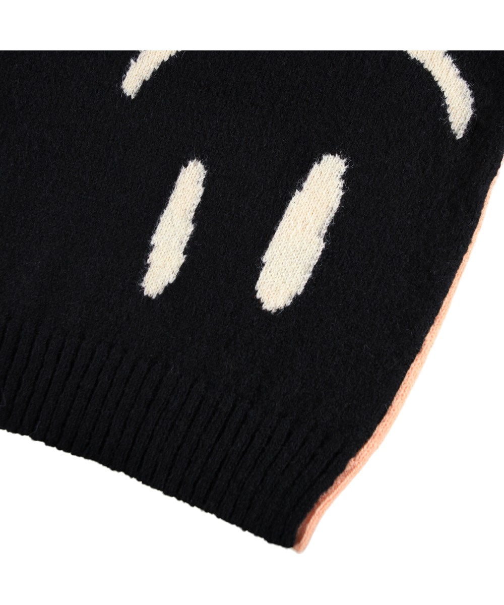 Bello - Double Smile - Gestrickter Pullover in Rosa und Schwarz für Kinder aus einer Alpakawollmischung mit lächelnden Gesichtern.