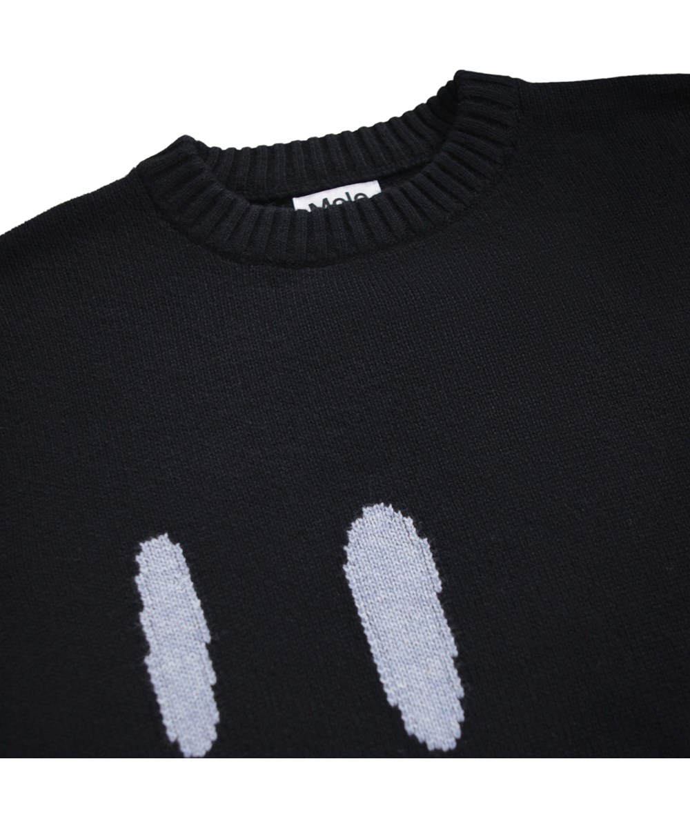 Bello - Smile Smile - Schwarzer Strickpullover für Kinder aus einer Mischung von Wolle und Baumwolle mit einem lächelnden Gesicht.