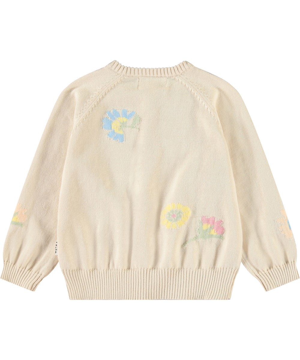 Brody - Pastel Flora - Strickjacke für Baby aus weicher Öko-Baumwolle. Die Strickjacke ist beige mit Blumen.