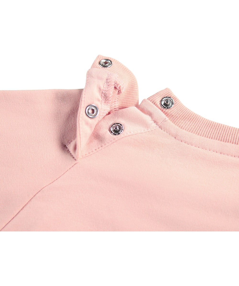 Disc - Rose Cloud - Rosa Sweatshirt für die Kleinen aus weicher Öko-Baumwolle mit einem gestickten lächelnden Gesicht auf der Vorderseite.