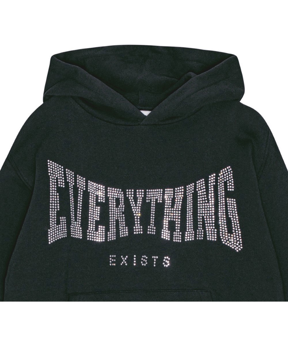 Maxx - Black - Weicher und warmer schwarzer Öko-Baumwoll-Hoodie mit übergroßer Passform. Pailletten-Kunstwerk "Everything Exists" auf der Vorderseite.