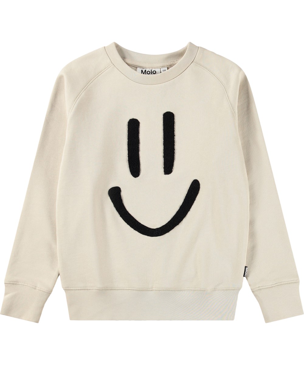 Mike - Summer Sand - Beiger Kinderpullover aus Bio-Baumwolle mit einem lächelnden Stickmotiv
