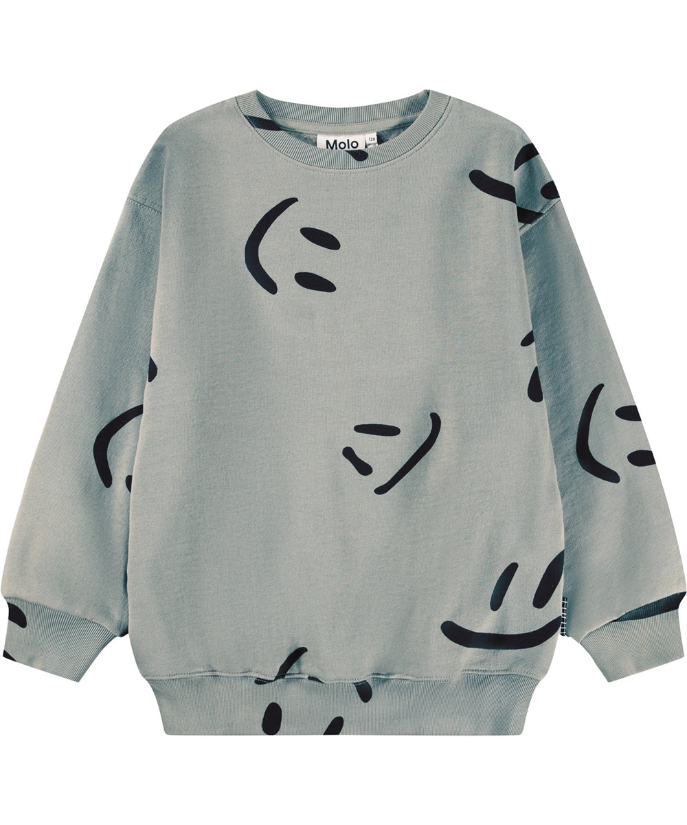 Monti - Big Smiles Fall - Beiges Sweatshirt für Kinder aus weicher Öko-Baumwolle mit einem Aufdruck von lächelnden Gesichtern.